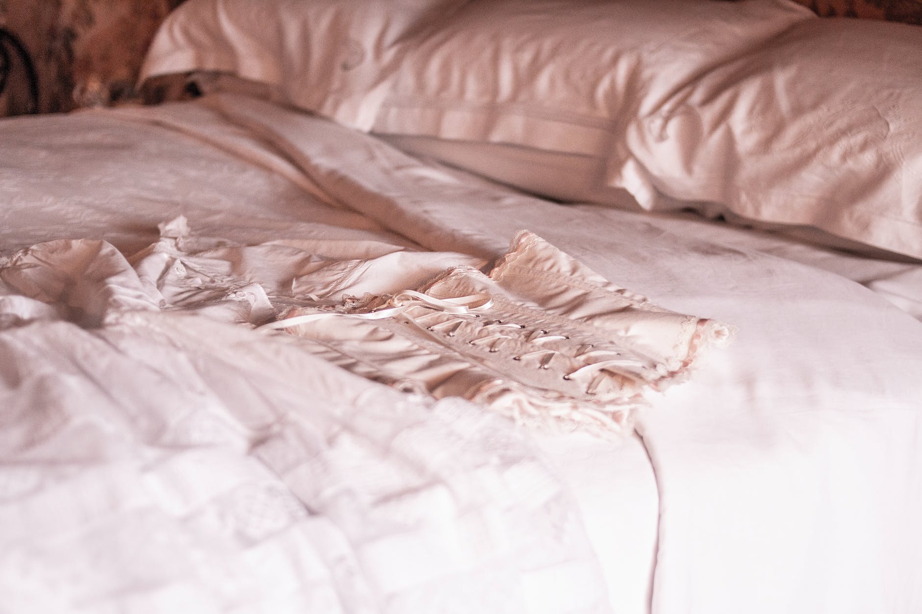 white corset on bed