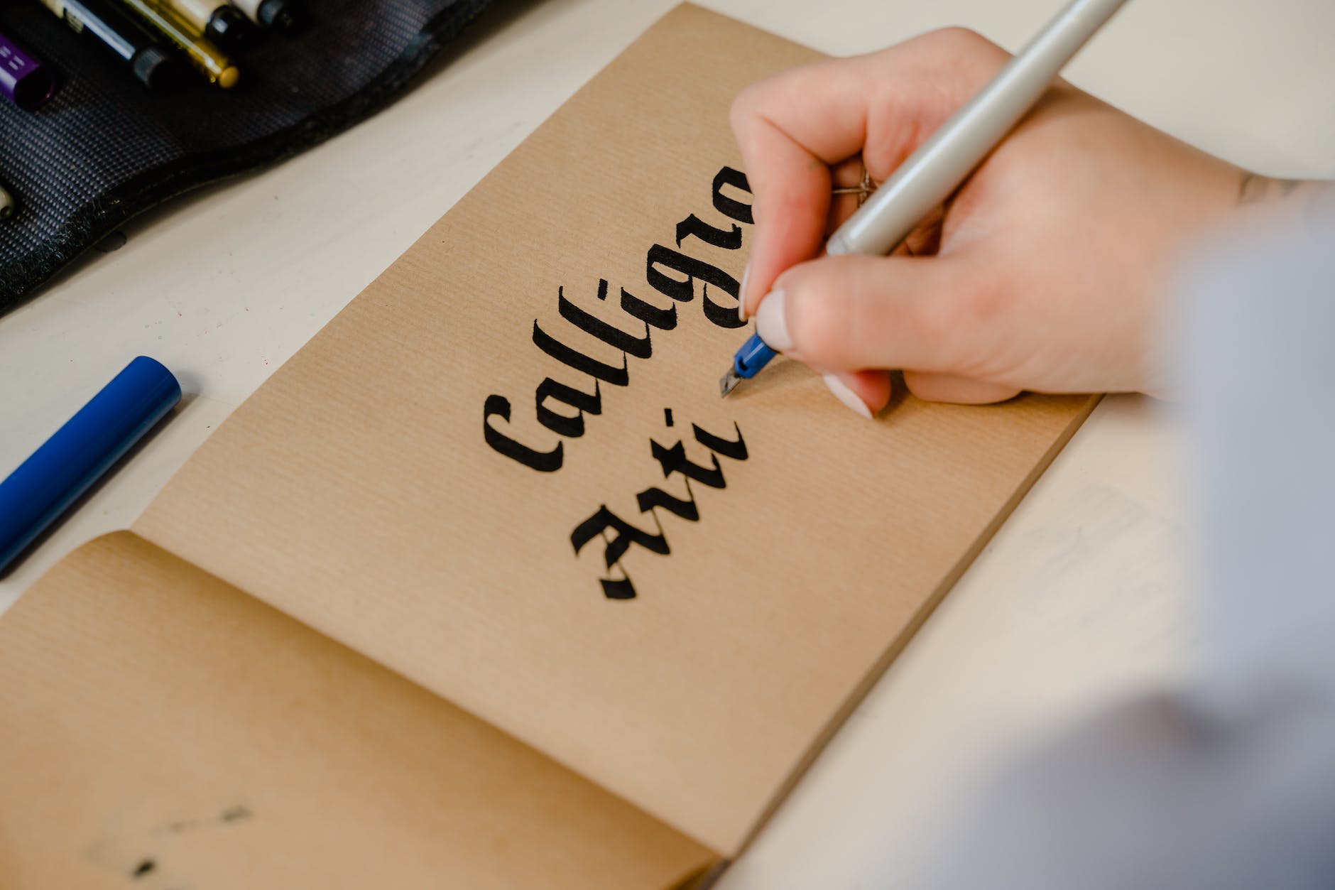 person writing on brown paper