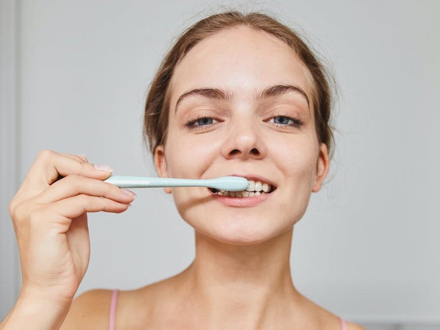 a woman brushing her teeth