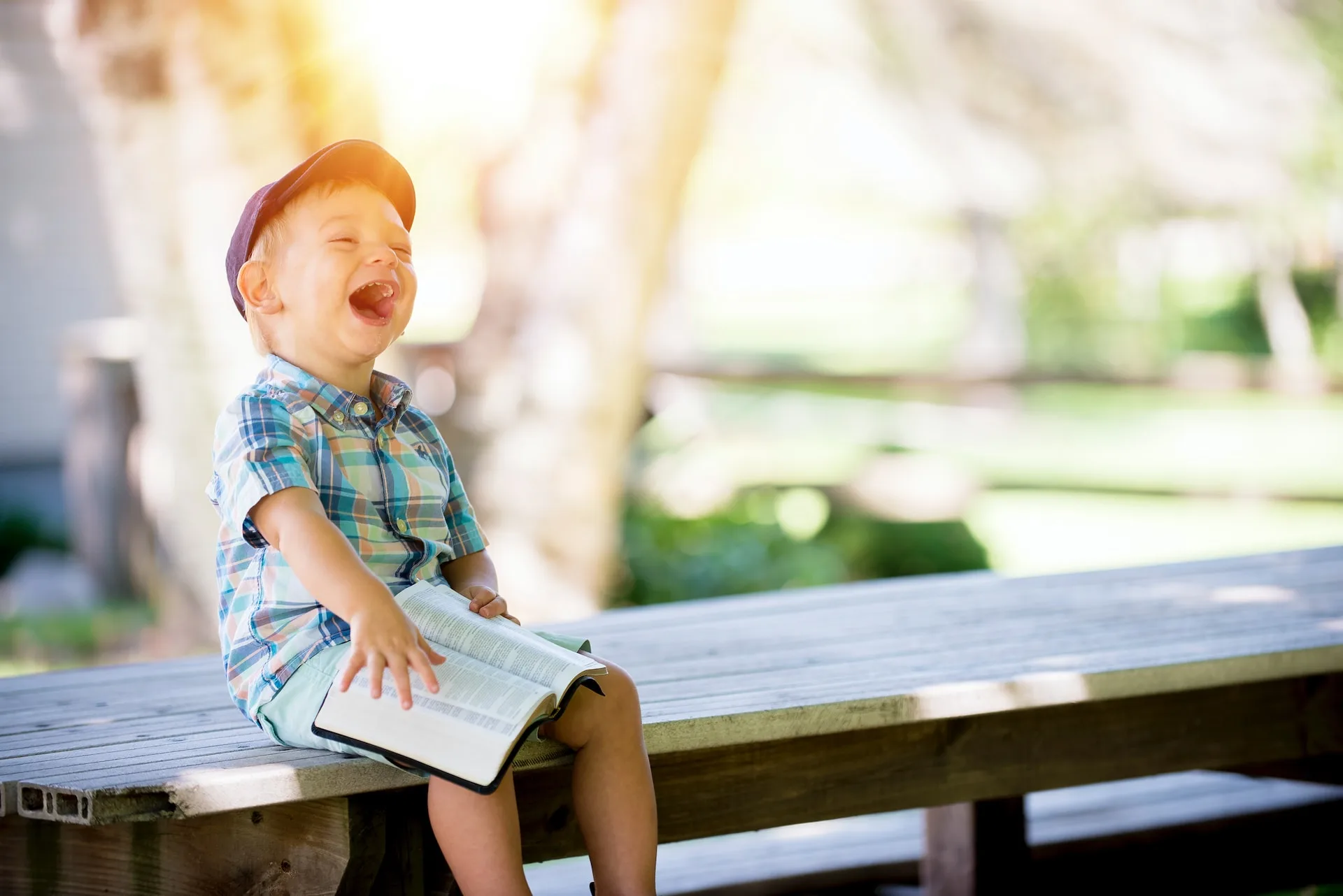 Little Boy Laughing with book