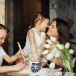 photo of woman playing with her children