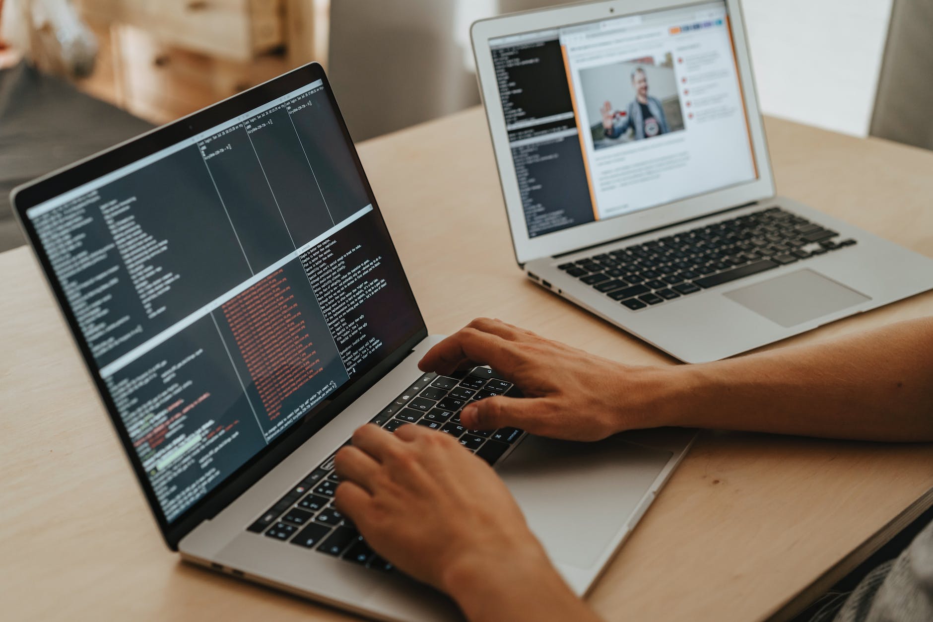 person coding on a macbook pro