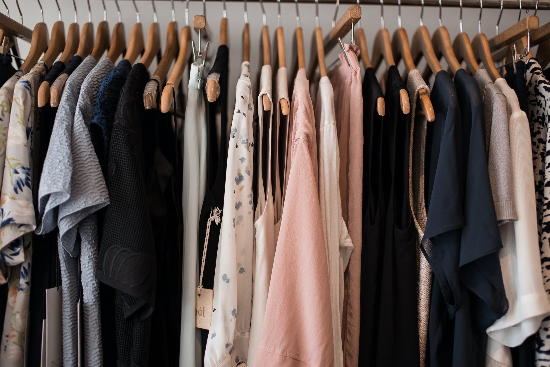 women clothes on hangers in shop